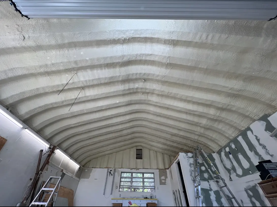 Spray polyurethane foam applied to the underside of a metal roof deck in Kingman